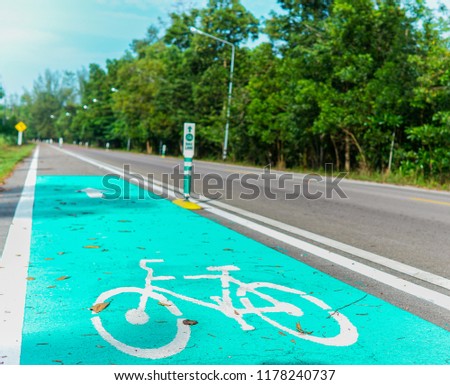 Road for bicycles And signs for bicycles.Rural road with leaves on the street.