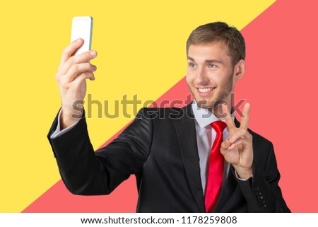 Handsome businessman taking a selfie with a mobile phone