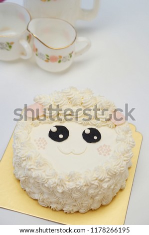 A sheep Birthday cakes with afternoon tea set on white background