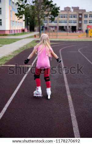 active lifestyle in a modern city - active lifestyle in a modern city - stylish girl roller-blading in a stadium