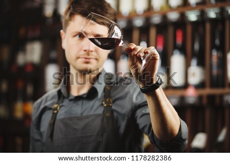 Bokal of red wine on background, male sommelier appreciating drink Royalty-Free Stock Photo #1178282386