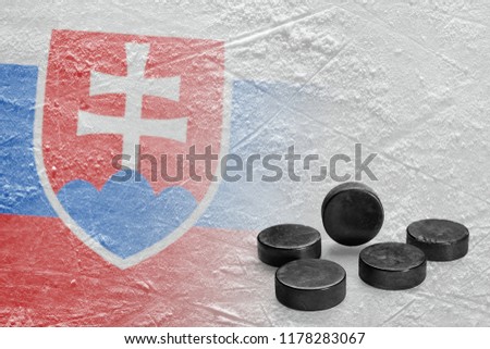 Image of the Slovak flag on ice and hockey pucks. Concept, hockey