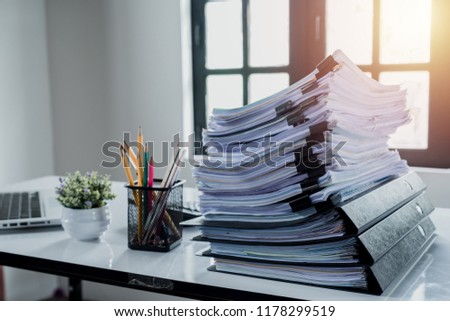 Stack of business paper on white desk, Pile of unfinished documents on office desk