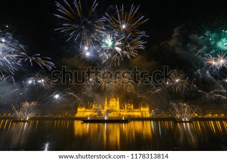 Fireworks reflecting of the surface of the Danube river in Budapest, Hungary with the house of Parliament in the background on August 20, National Holiday