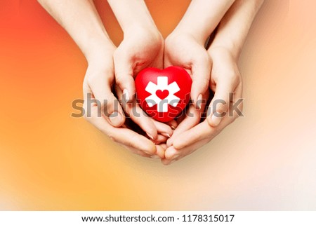 Man and woman holding red heart