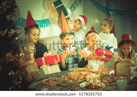 happy germany children presenting gifts during Christmas dinner