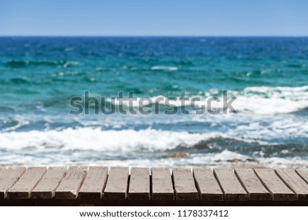 Wooden pier surface with blurred sea on a background, natural photo taken from Cyprus island coast