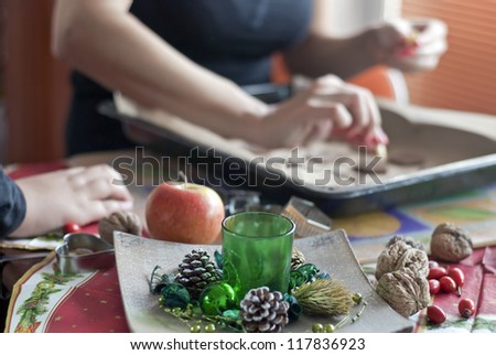 Mother's and son's hands going to the Christmas table Royalty-Free Stock Photo #117836923