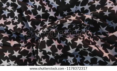 black fabric with white stars folded or folded for background texture