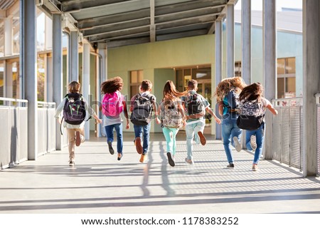 Elementary school kids running at school, back view close up Royalty-Free Stock Photo #1178383252
