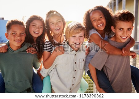 Elementary school kids smiling to camera at break time Royalty-Free Stock Photo #1178390362
