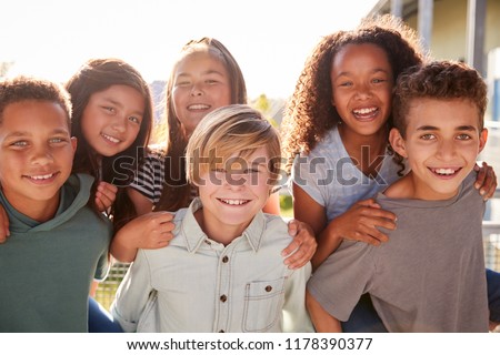 Elementary school kids smiling to camera during school break Royalty-Free Stock Photo #1178390377