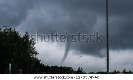 Kaunas, Lithuania - 08 20 2017: Small tornado. Whirlwind. Hurricane. Storm. Very unusual natural phenomenon in Northern Europe.  Royalty-Free Stock Photo #1178394940