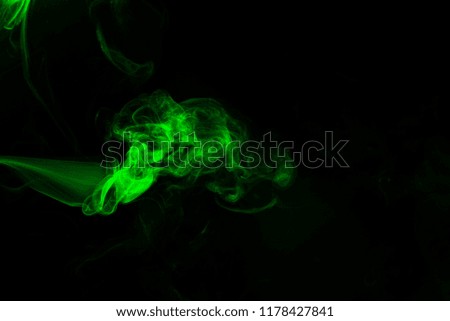Green coloured smoke abstract lighting on a black background