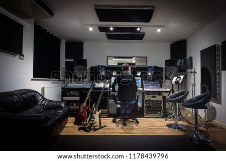 Recording Studio Control Room - with Engineer. Commercial, Modern Musical Environment. Ideal for learning or training courses for writing at a home live studio, computer recording workstation. Royalty-Free Stock Photo #1178439796