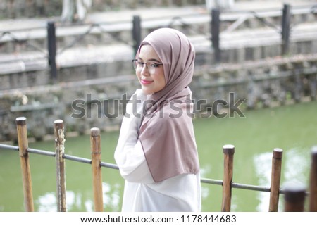 Portraiture of young cute Asian hijab girl at park in the morning sight
