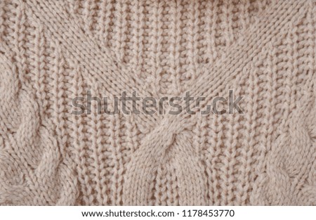 Sweater or scarf texture large knitting. Knitted jersey background with a relief pattern