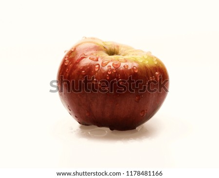 Apple in red and yellow colors isolated on white background. Fruit with shiny peel and water drops. Green grocery and harvest concept