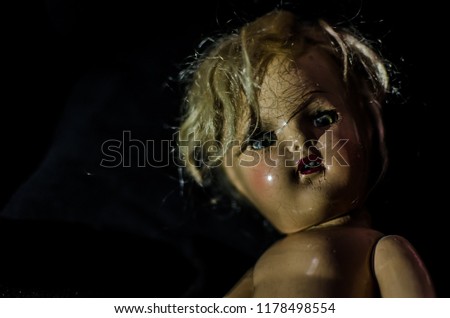 portrait of creepy doll smile in high contrast concept