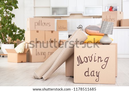 Moving boxes and household stuff in kitchen. Space for text Royalty-Free Stock Photo #1178511685