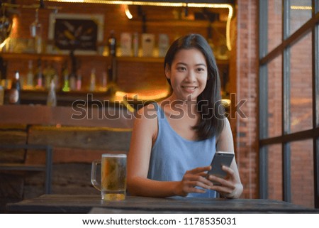 Pictures of women sitting at a cafeteria, drinking beer, playing a fun online phone