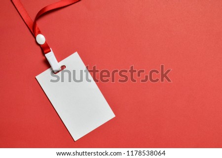 Top view close up of blank white badge name tag isolated on paper pastel background. Flat lay creative of mock up. Business office background view.
