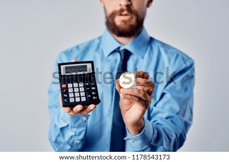 calculator and coin bearded man in suit                        