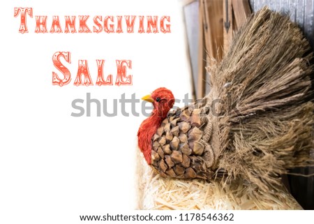 Thanksgiving turkey made out of pinecone and burlap and straw at side of white background  - selective focus  - Thanksgiving sale
