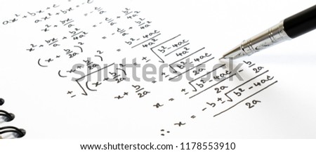 Handwriting of mathematics quadratic equation formula on examination, practice, quiz or test in maths class. Solving exponential equations background concept.