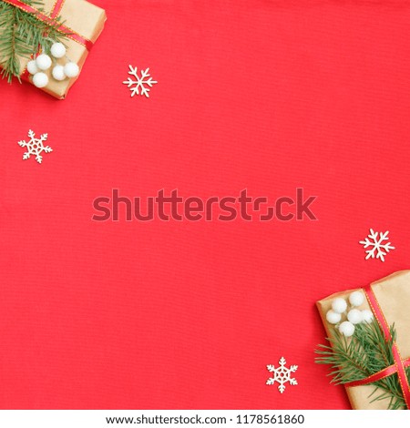 Christmas gift boxes decorated with craft paper and white snowflakes on red background top view. Merry christmas greeting card. Happy New Year. Flat lay.