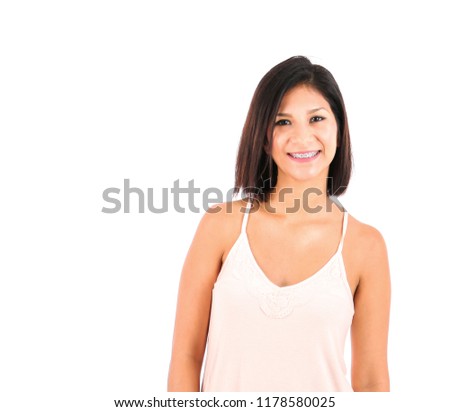 Happy young latin woman smiling against a white background