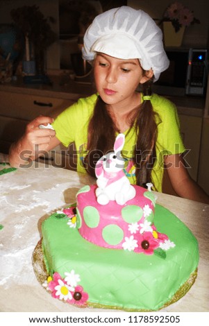 A girl decorating a cake