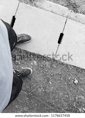 black and white concept - Man take picture of shoes before running in the field