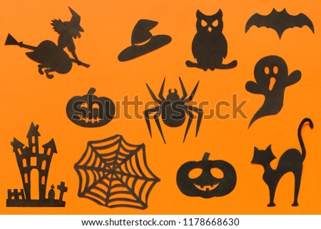 Happy Halloween Set cut out of black paper silhouettes pumpkin, witch, ghost, cat, owl, spider, web, hat, bat, castle on orange background. Concept Paper cut style. Top view