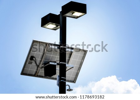 Street lamp with a solar panel against blue sky