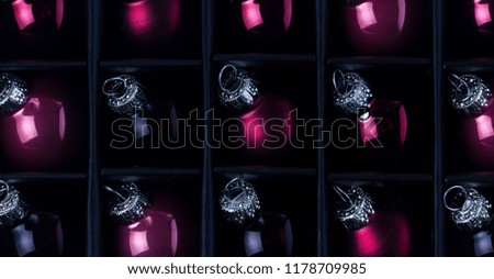 Christmas flat lay scene with pink and violet glass balls rows