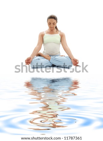 sporty girl practicing padmasana lotus pose on white sand