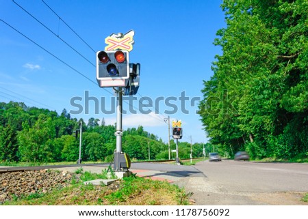 Semaphores in front of the railway crossing. Warning signaling on railway in the Czech Republic. Car arriving at the railway crossing