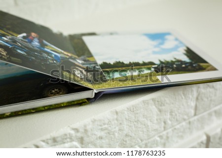 High angle view open book with album at home