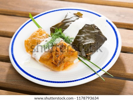 Cabbage and grape rolls in leaves at plate,  dish of Eastern European cuisine