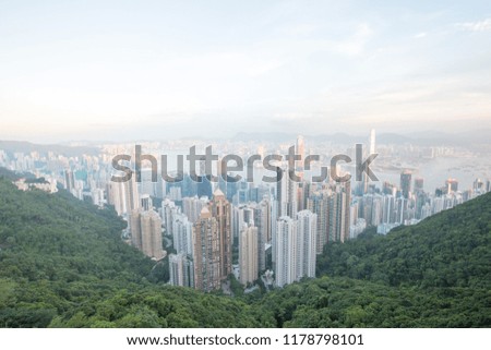 a city in asia with traffic and a river between skyscrapers