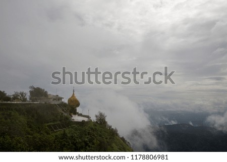 a very old temple in asia for praying to buddha between mountains