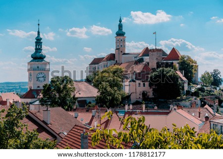 Picture of the tower of town hall and the castle of Mikulov on the hill.