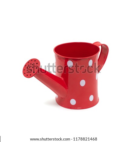 red polka dot watering can isolated on white