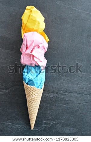 Ice Paper - Crumpled paper in the form of ice cream balls in an ice cream cone against a plain background