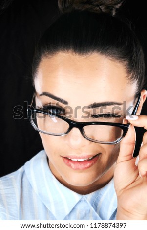 Beauty portrait of a young healthy woman holding glasses and looking at camera