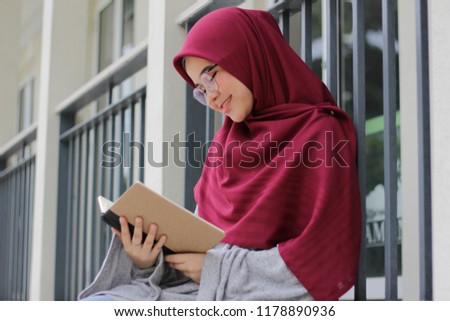 Cute little Asian girl wearing hijab just chill at the park in the morning. Portrait of beautiful ladies wearing hijab fashion. Royalty-Free Stock Photo #1178890936