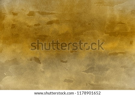 Luxury gold watercolor ombre leaks and splashes texture on white watercolor paper background. Natural organic shapes and design.
