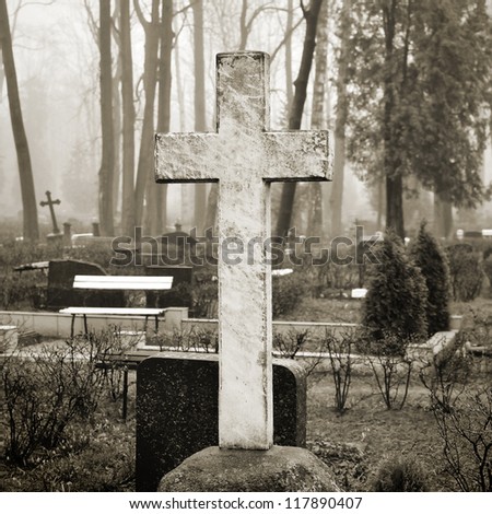 cross in fog at the cemetery