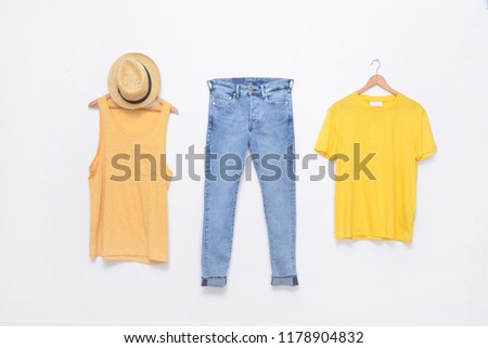 Two yellow clothes on hanging and blue jeans,hat  -white background
